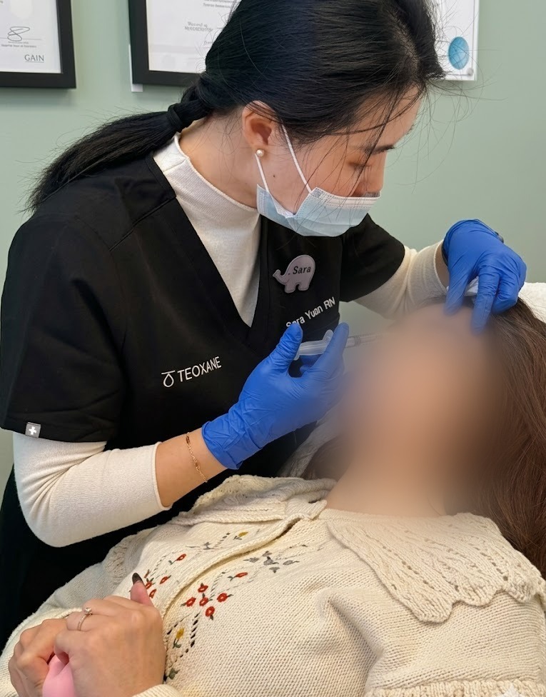 Sara Yuan RN performing an aesthetic injection