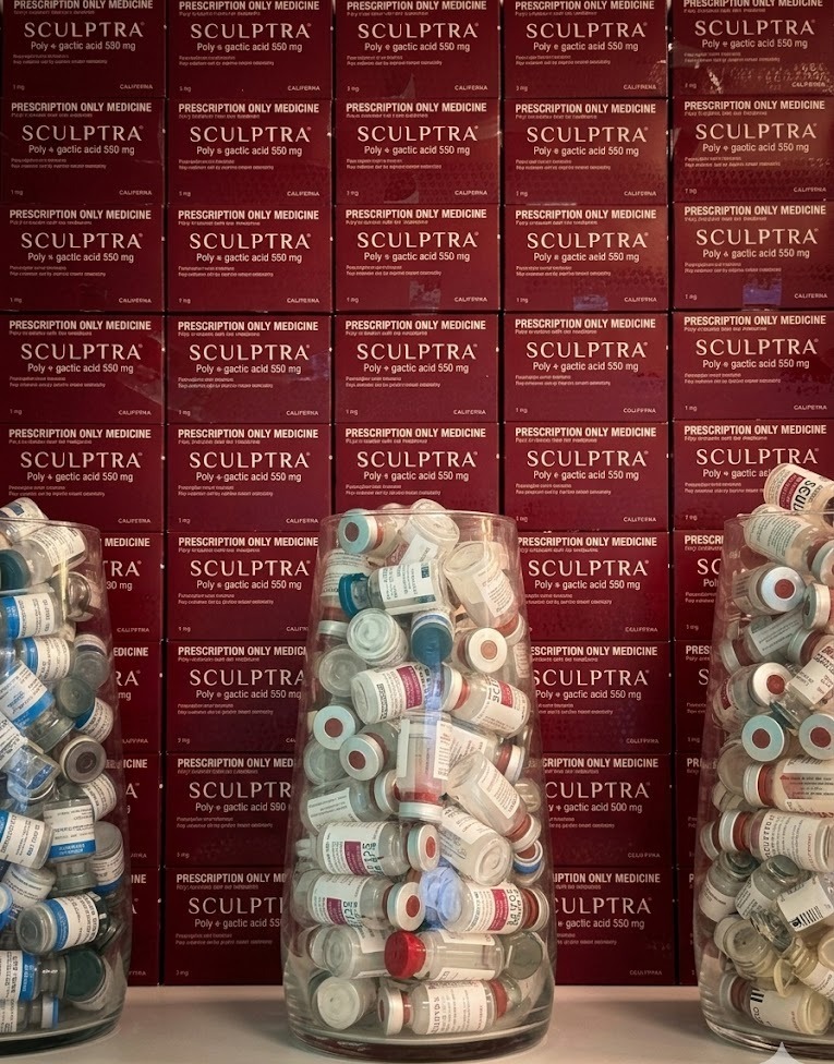 Wall of Sculptra prescription archive — empty vials and boxes